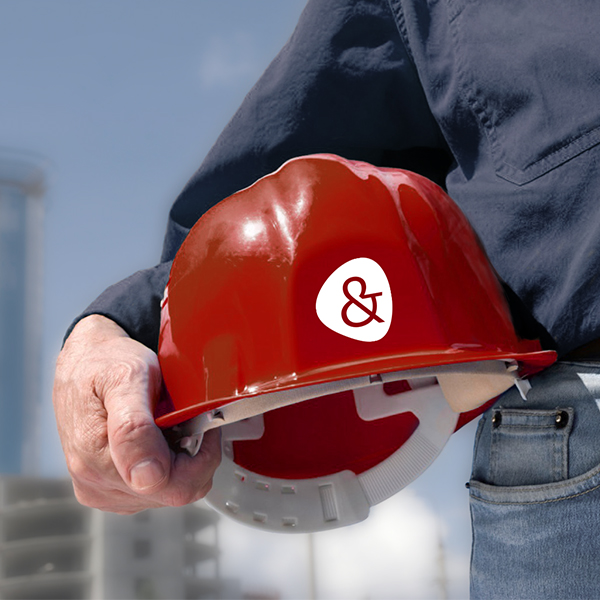 Close-up of a construction worker's helmet being held by a construction worker | Employer-owned accident insurance with NW Assekuranz